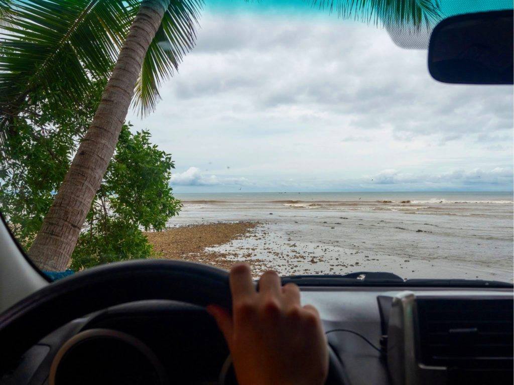 A view from the drivers point of view, looking out at the sea.