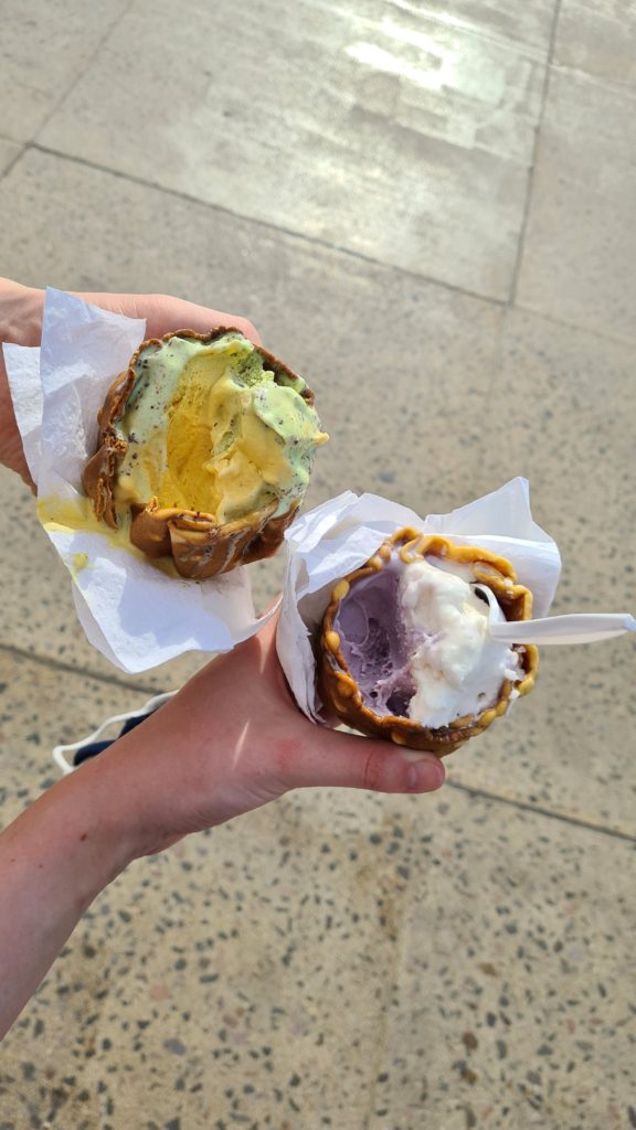 Two half-eaten, brightly coloured ice creams.
