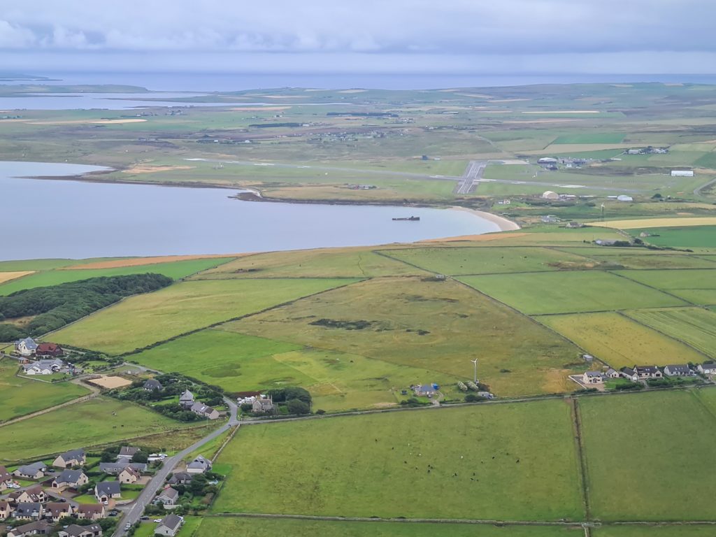 Kirkwall airport fades out of view as the photograph is flown away in a small passenger plane.