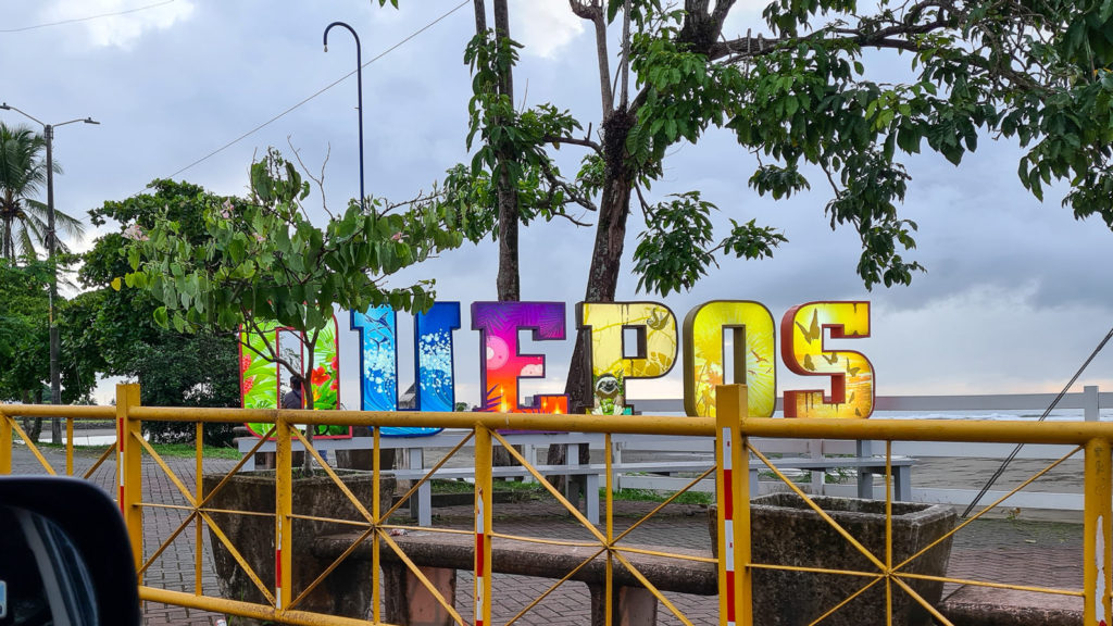 Each letter of the "Quepos" sign is a different colour and depicts a different attraction in the area.