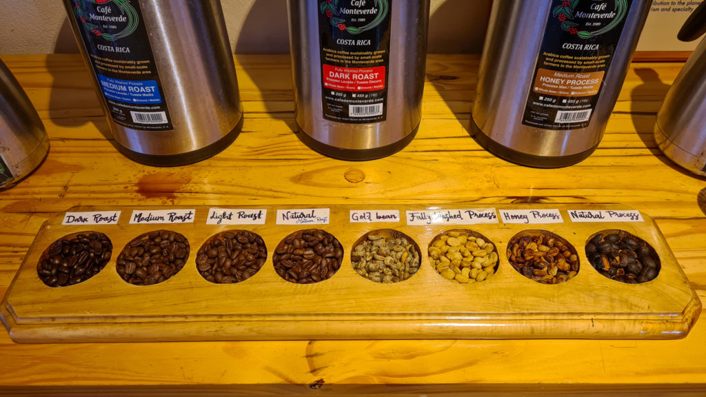 Eight varieties of coffee beans and roasts are laid out in a display to show their differences.