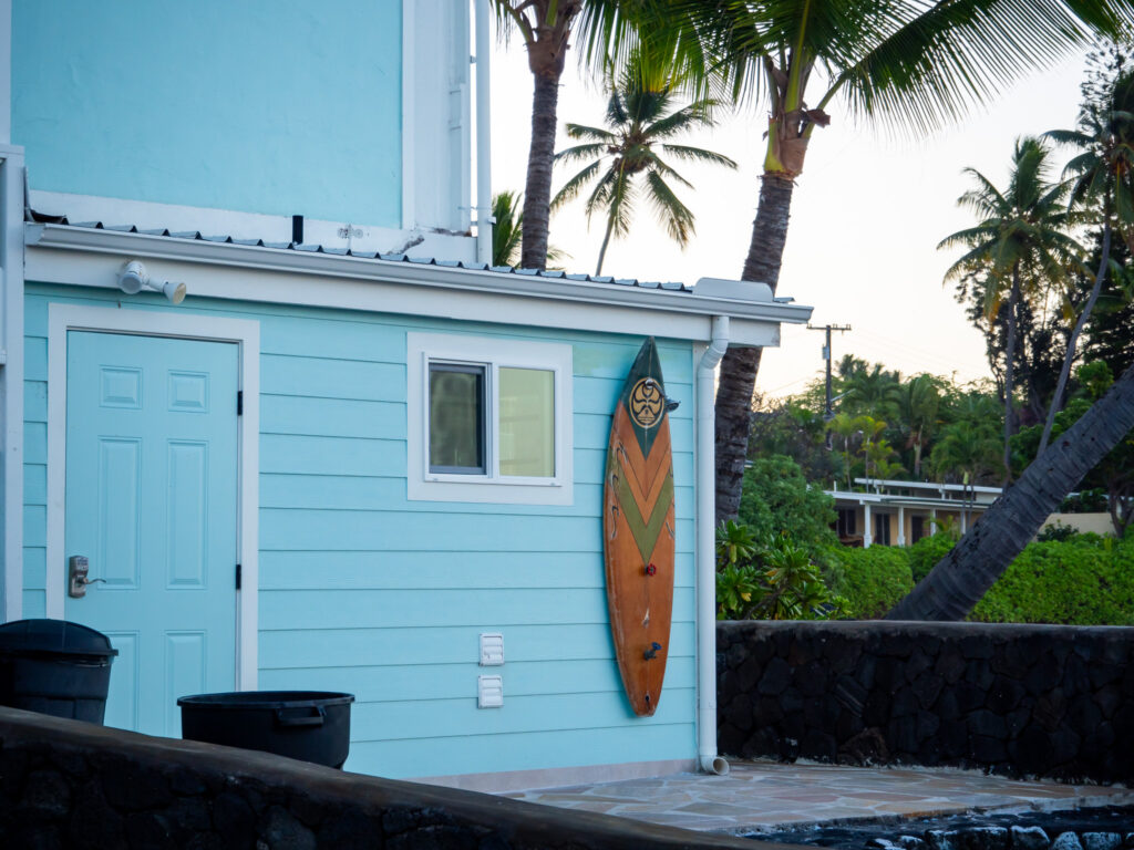A view of the outside shower at Kona Tiki Hotel. The shower is mounted on the top of a wooden surf board.