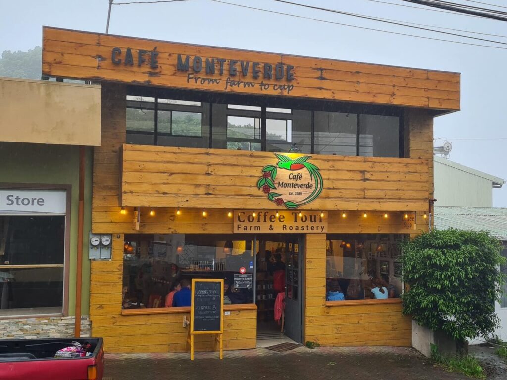 The outside of Cafe Monteverde with a picture of a quetzal above the doorway.