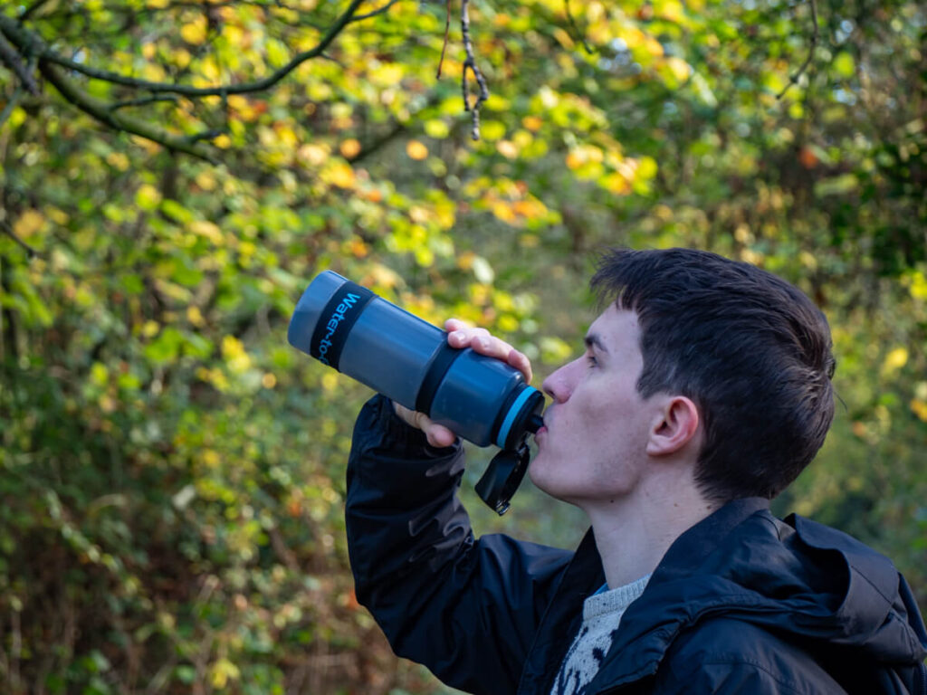 Dan drinking from his water bottle which is made from re-purposed sugarcane waste.