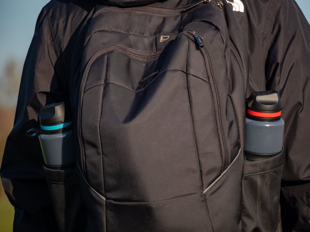 A pair of filter water bottles in a black backpack.