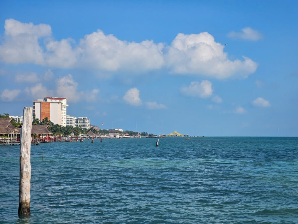 The Cancun coastline with its many docks and palapas in the sunshine.