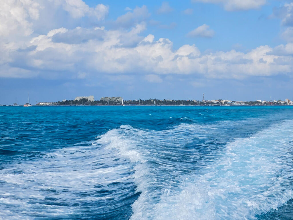 Large seaside hotels on Isla Mujeres as viewed from a boat.